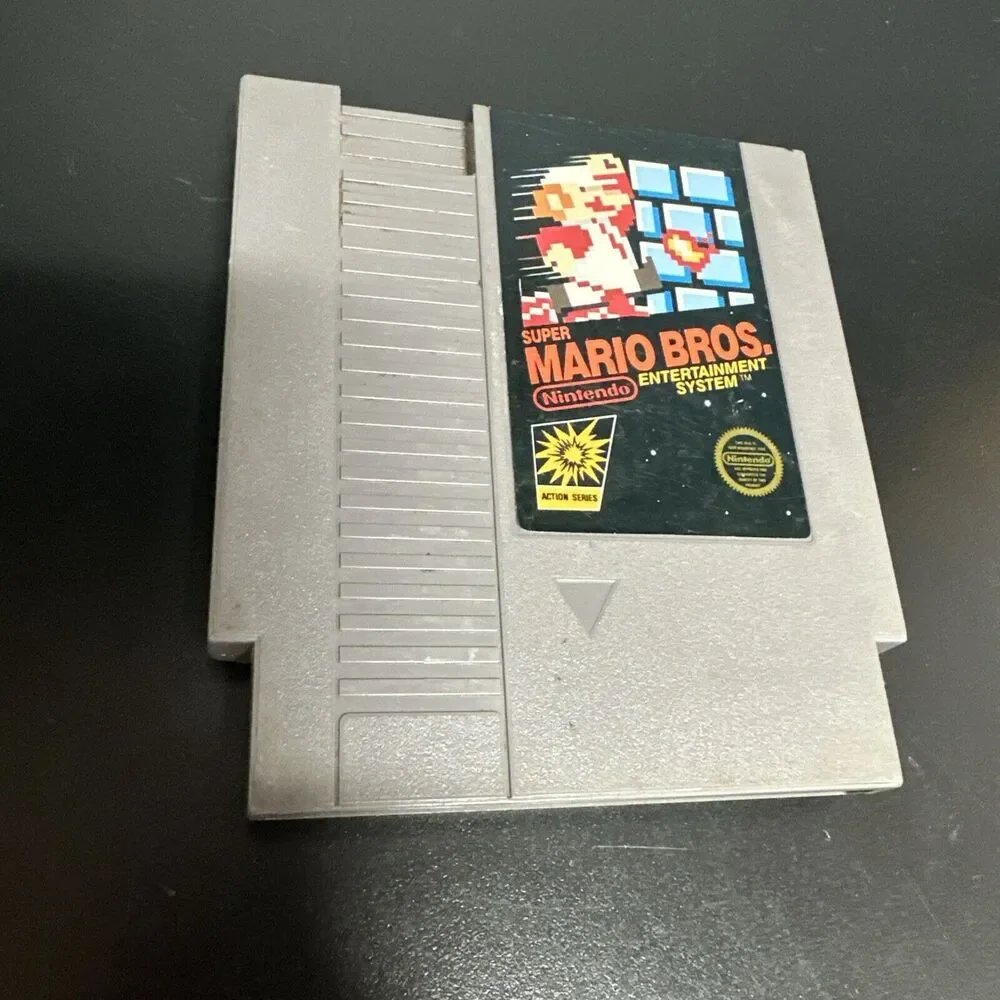 NES PAPERBOY TOY VIDEO GAME AND  SUPER MARIO BROS CARTRIDGE.